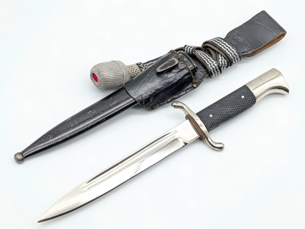 WWII German Tiger Solingen Firemans Dress Dagger w/ Scabbard Frog & Knot: Features a nickel plated blade, nickel plated guard, checkered plastic handle scales, and a nickel plated eagles head pommel. Bayonet is in nice condition with some scratches and pits on the polished