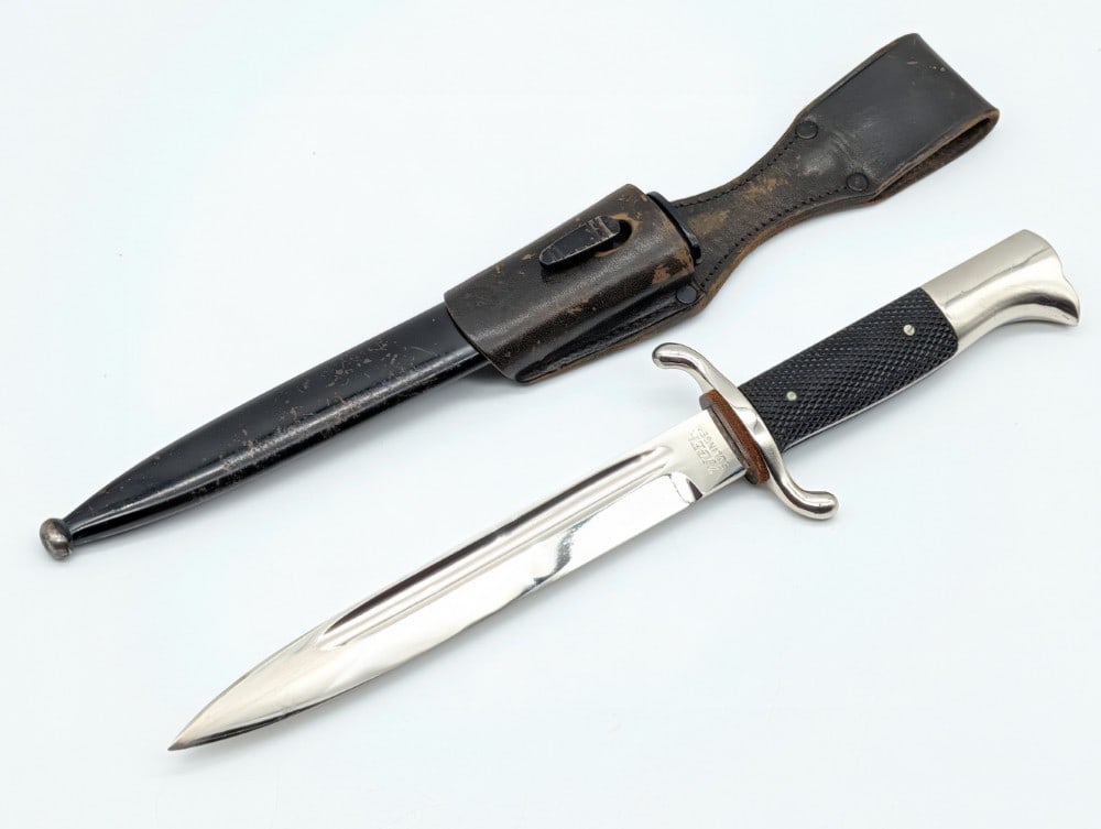 WWII German Tiger Solingen Fireman's Dress Bayonet w/ Scabbard & Frog: Features a nickel plated blade, nickel plated guard, checkered plastic handle scales, and a nickel plated eagles head pommel. Bayonet is in very nice condition with light scuffs on the blade, and ligh