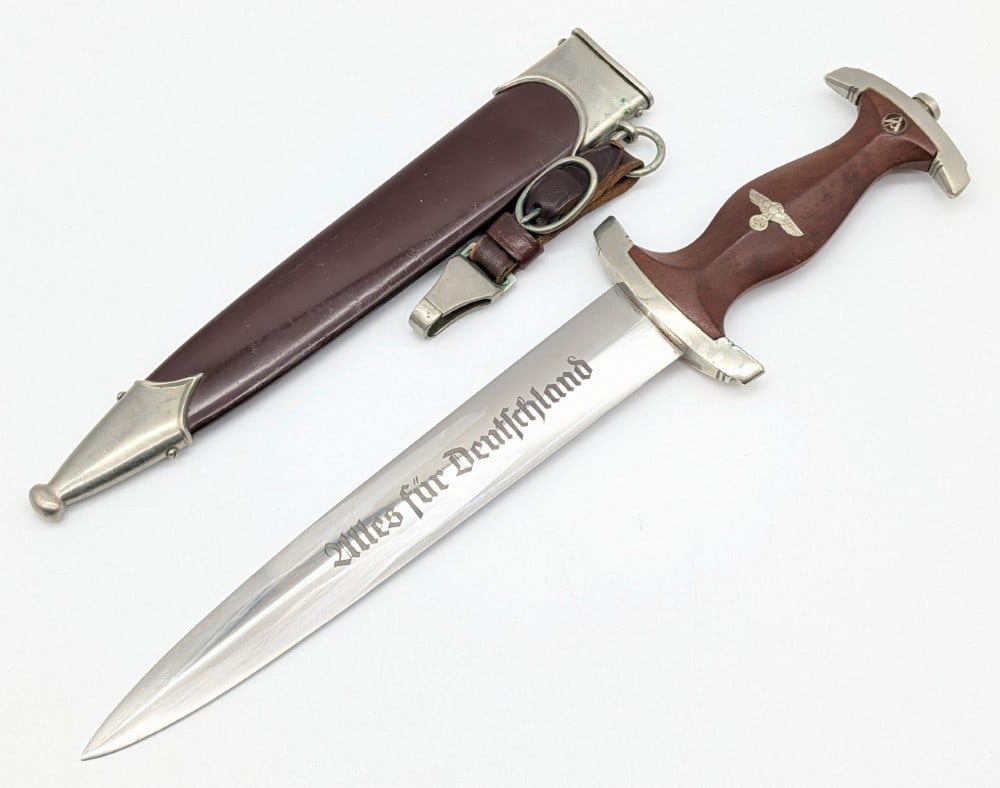 WWII German Christianswerk SA Dagger w/ Scabbard & Hanger: Features the phrase “Alles für Deutschland” or "Everything for Germany" etched on the blade, nickel silver guard and pommel stamped ?JN, and a walnut handle with the SA and Nazi Eagle inserts