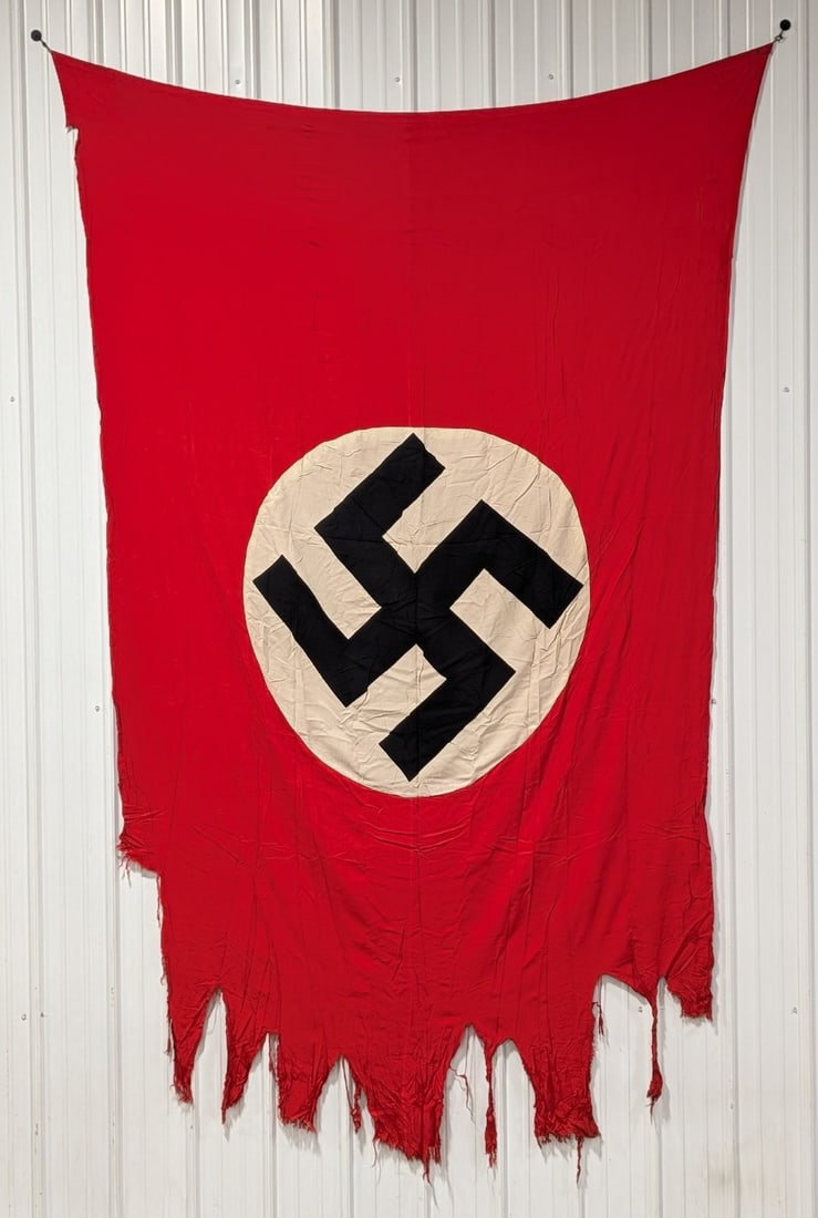 WWII German NSDAP War Tattered Flag: This flag has a lot of great character with the worn and tattered bottom edge like an item of war. The flag comes with a small letter dated 1978 written by the original owner stating that the flag was