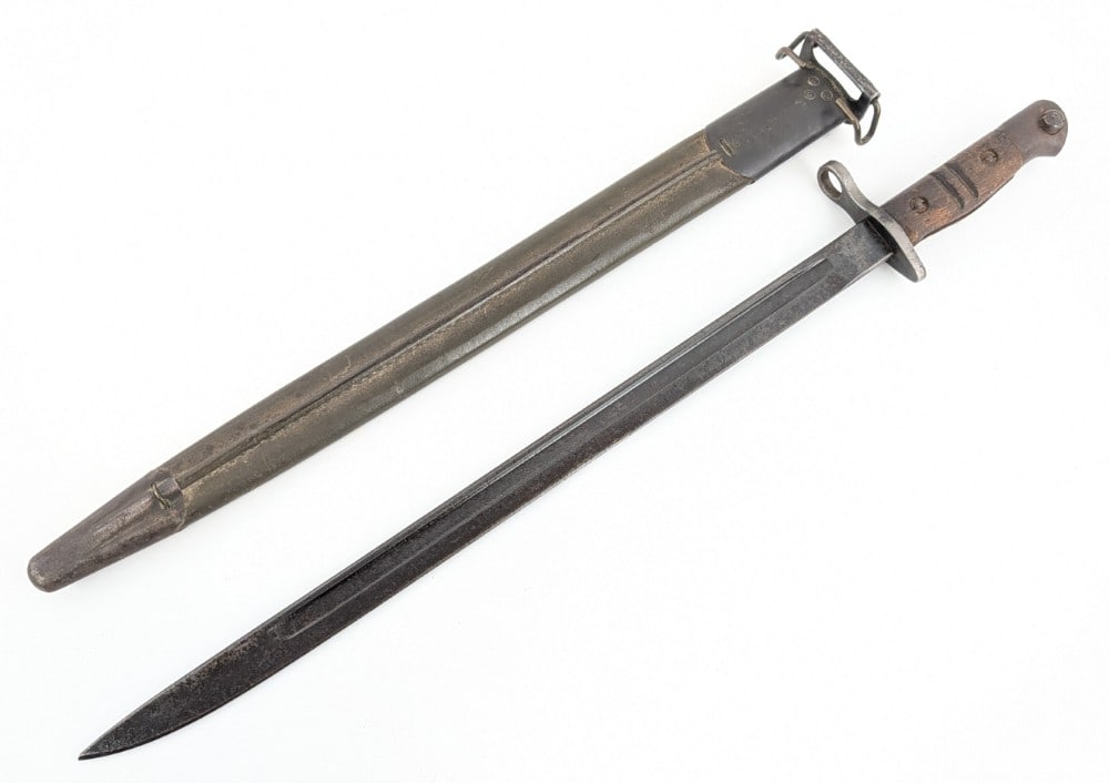 WWI U.S. Army Remington Model 1917 Bayonet w/ Scabbard: Bayonet is in nice used condition with some pitting and scratches on the blade, nice tang stamps, and scratches and tarnishing on the guard and handle from use and age. Blade length measures 17in and