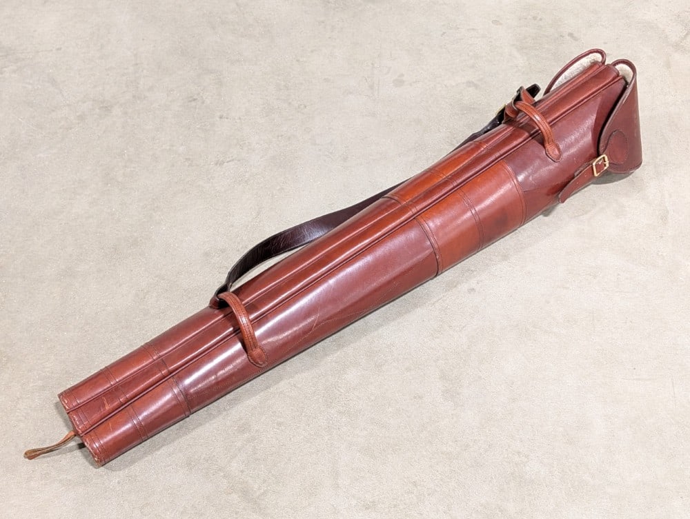 High Quality Diana Leatherworks Double Gun Slip: A quality made piece with a fine cherry stained finish, sherpa wool lining, and a hardened exterior to protect your firearms. This slip has an extra center slot for an additional barrel. Perfect for d