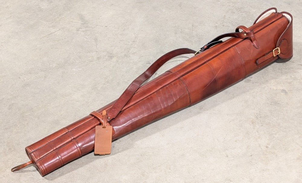 High Quality Diana Leatherworks Double Gun Slip: A quality made piece with a fine cherry stained finish, sherpa wool lining, and a hardened exterior to protect your firearms. This slip has an extra center slot for an additional barrel. Perfect for d