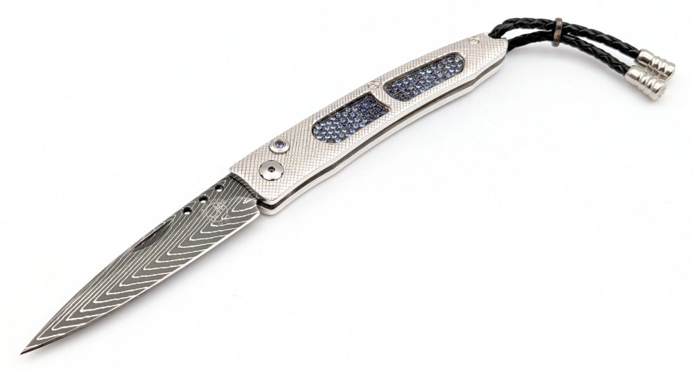 2013 William Henry Fine Knives B06 Ventana Azure Damascus & Sapphire Folding Knife w/ Box: Knife is number 21 of 50. Features a Rob Thomas crafted Herring Bone damascus blade, a Rhodium plated nickel silver handle with genuine sapphires hand set in nickel silver, and a sapphire set in a gol