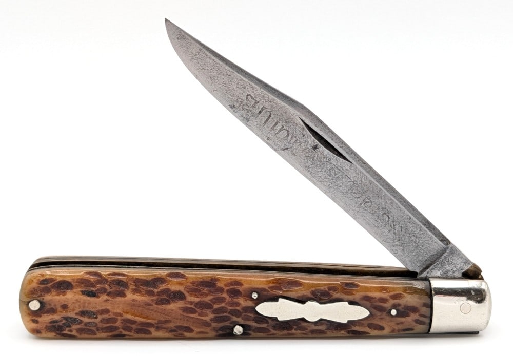 Antique Cattaraugus Jig Bone Linerlock Jack Knife: Knife is in good aged condition with a faint etching on the blade with light scratches and carbon spots, scuffs and some dings on the bolsters, and nice handle scales with a pin crack on the front han