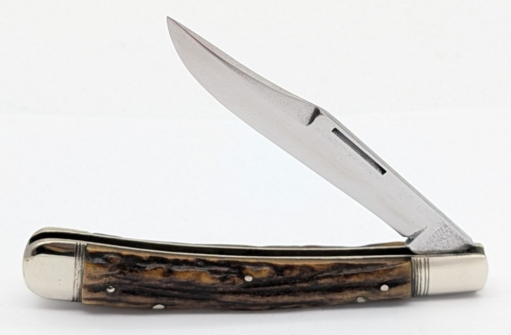 Antique Winchester Stag Jumbo Trapper 1950: Knife is in aged cleaned condition with scratches and material loss on the polished blade, scratches and dings on the polished bolsters, a repaired chip on the front handle scale, and a repaired chip