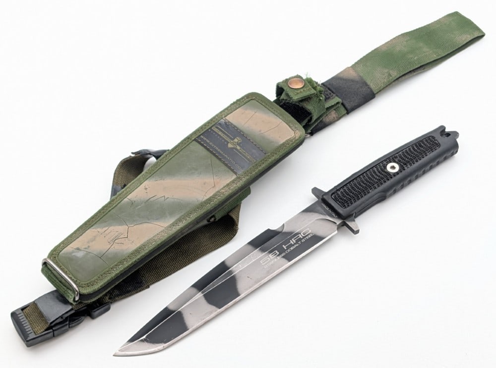 Extrema Ratio Harpoon Fighter w/ Sheath: Features a black and bead blasted finish blade, integral guard, full tang construction, and a nonslip handle. Knife is in good condition with some scratches and wear on the blade from use. Blade lengt