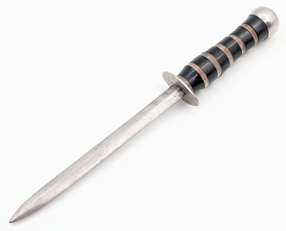 WWII Pacific Theater Fighting Dagger: Features a double edged narrow blade, aluminum disc guard, stack aero plexi and black plastic handle, and threaded aluminum pommel. Knife is in good original condition with carbon spotting on the blad