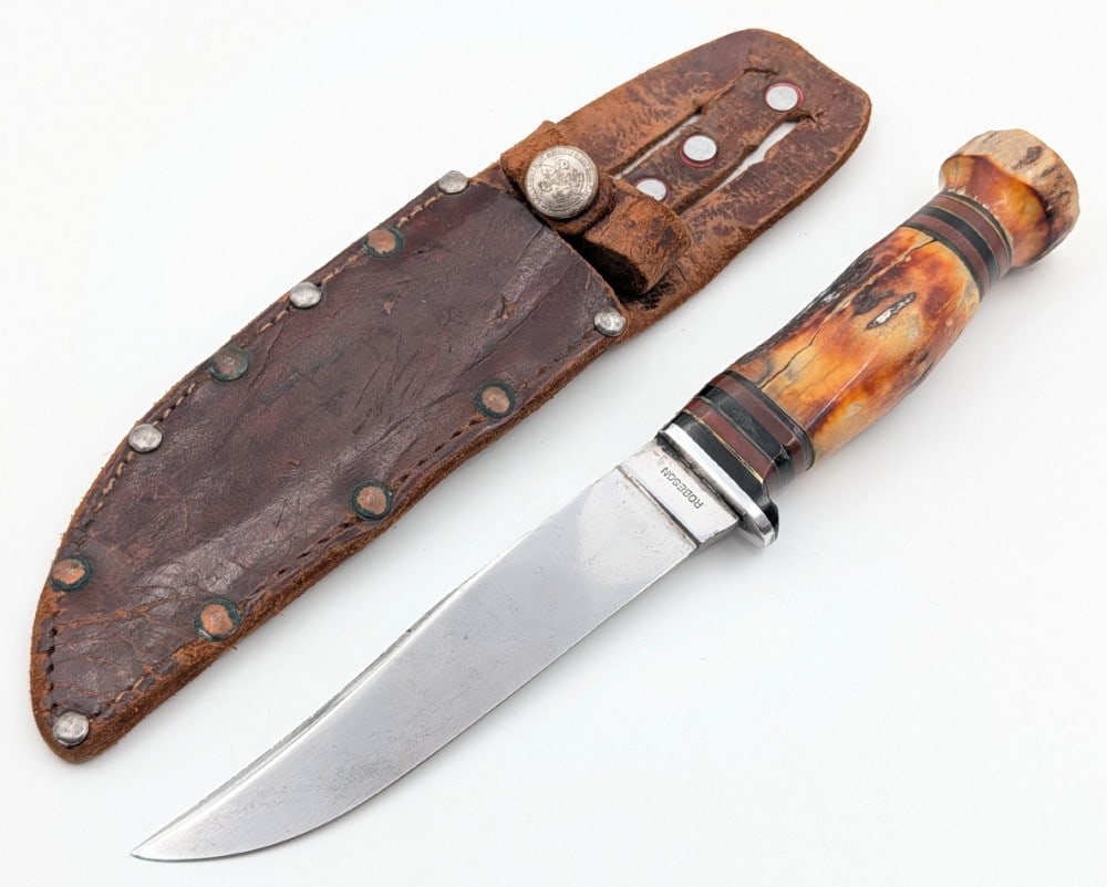 Robeson Stag on Stag Hunting Knife w/ BSA Sheath: Features a mirror polished blade, reduced aluminum guard, stag handle, and a stag large nut pommel. Knife is in good cleaned condition with scratches and some pits on the polished blade, and the handl