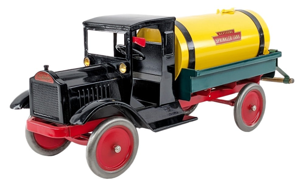 Restored Keystone Packard Sprinkler Tank Truck: Restored Keystone Packard Sprinkler tank truck. The truck has a very nice restoration done overall. Displays well with sprinkler bar, yellow tank, black cab, Packard decal, and red center disc wheels.