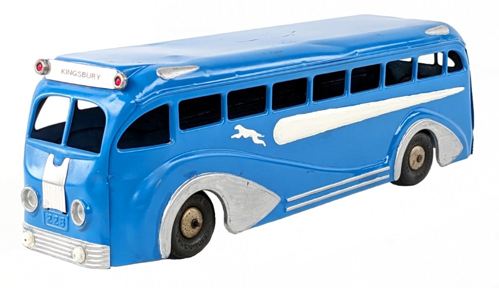 Restored Kingsbury Windup Greyhound Bus: Partially restored Kingsbury windup Greyhound bus. The bus is missing the windup key. The bus has some scratches, dents, and age wear. The underside of the bus was not fully painted. Measures approxim