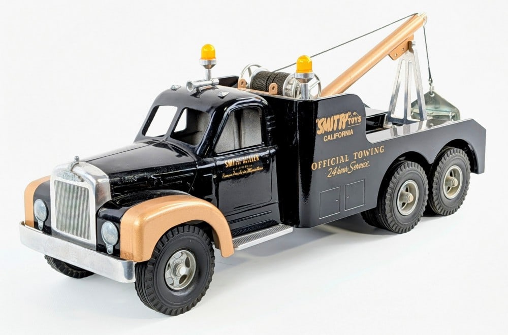 Fred Thompson Smith Miller B Mack Tow Truck: Fred Thompson Smith Miller "Smitty Toys" Official Towing wrecker tow truck. The truck displays well in black and gold with sirens, taillight reflectors, and working winch. The truck has some dust from