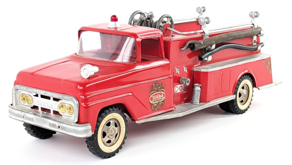 Tonka Suburban Pumper Fire Truck: Tonka Suburban Pumper square fender fire truck. The truck looks like is has some old overpaint, replacement parts, and wear from age. The ladder and hoses have been replaced. Measures approximately