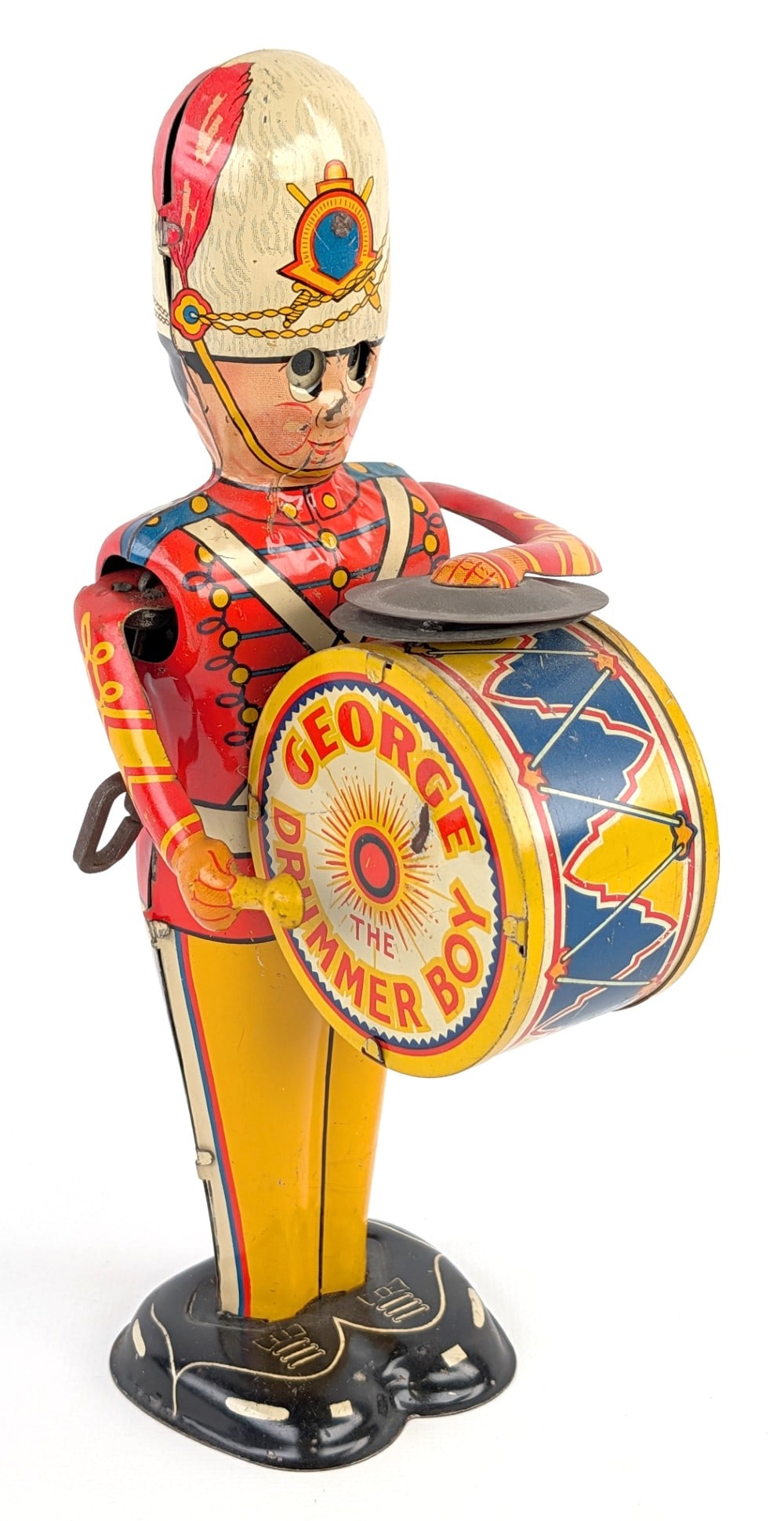 Marx Tin Windup George The Drummer Boy: Marx tin litho windup George the Drummer Boy. The windup mechanism works. The drum shows some paint loss wear the mallet rubs. Displays well with good color and graphics. Measures approximately 9"