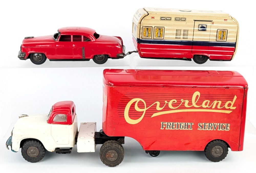 Japan Tin Friction Overland Freight Service Truck and Car w/ Camper: Japan tin friction Overland Freight Service truck and trailer plus car with camper trailer. The truck and trailer shows some paint crazing and wear from play and age. The car and trailer have some