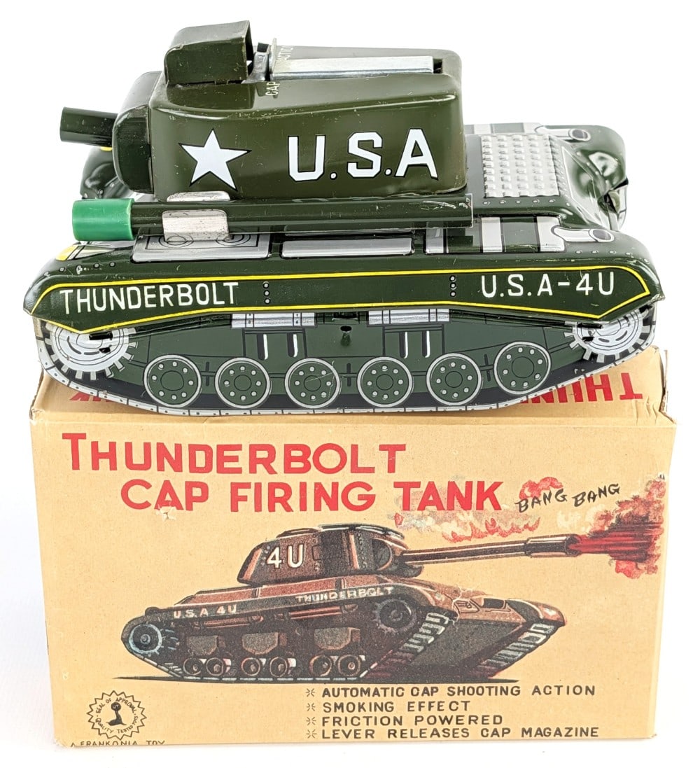 Japan Tin Thunderbolt Cap Firing Tank w/ Box: Thunderbolt cap firing tank in the original box by a Frankonia Toy made in Japan. The toy has a friction drive motor and works as it should. The tank has some minor scratches, but is overall in very
