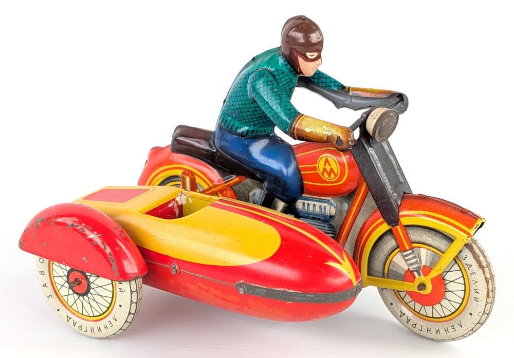 USSR Tin Windup Motorcycle w/ Sidecar: USSR tin litho windup motorcycle with sidecar. The windup mechanism works. The motorcycle displays well with great color and graphics. Good condition with light wear from play / age. Measures approxim