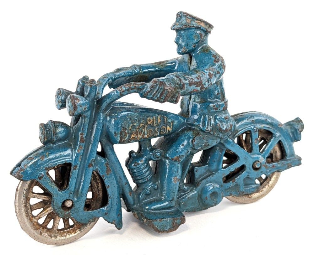 Hubley Cast Iron Harley Davidson Motorcycle: Hubley cast iron Harley-Davidson motorcycle. The motorcycle has nickeled spoked wheels and Harley-Davidson embossed on the tank with gold accent. It has some paint loss and wear from play and age. Mea