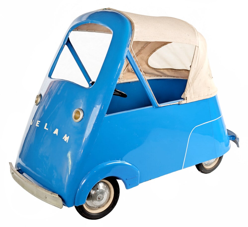 Velam Isetta Pedal Car: Very unusual Velam Isetta pedal car. The top of the car retracts so a kid would be able to climb in. The car has an older restoration done and shows some originality such as the canvas top. The rear b