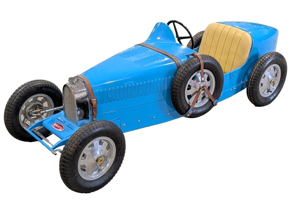 Electric Bugatti Children's Size Pedal Style Car: A fully operable electric Bugatti "Baby Bugatti" children's size pedal style car. The car has a shift lever to the right of the seat, pneumatic tires, electric motor, gauge on the dash, leather straps