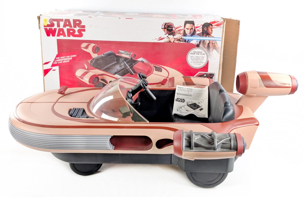 Luke Skywalker's Landspeeder Ride On Toy w/ Box: Luke Skywalker's Landspeeder with original box. The Landspeeder is powered by a 12 volt battery. Overall very good condition with some scuff marks and light use wear. Measures approximately 60" long.