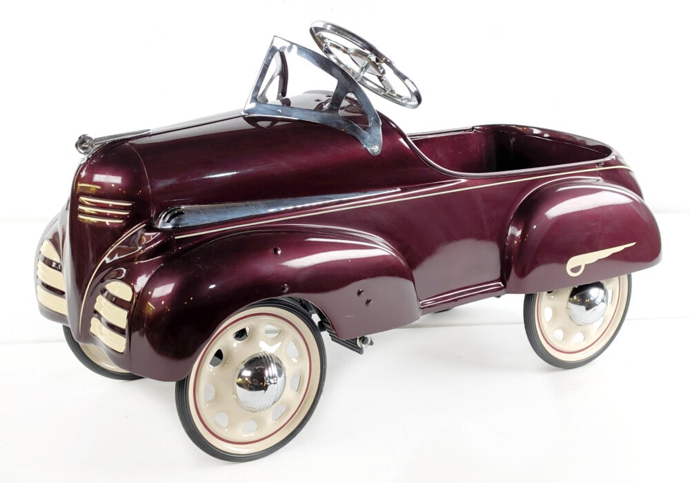 Restored Steelcraft Dodge Pedal Car: Professionally restored 1938 Steelcraft Dodge pedal car. The car displays well with a nice paint job and chrome features. Good condition overall. Measures approximately 36" long.