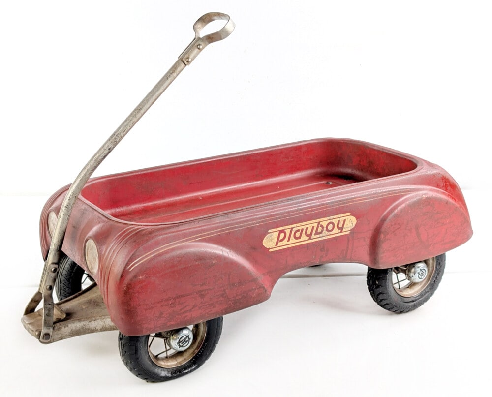 Original Steelcraft Playboy Wagon: Original Steelcraft Playboy Wagon. The wagon comes with 3 replacement pneumatic tires. The wagon shows paint loss and wear from play / age. Measures approximately 36" long.