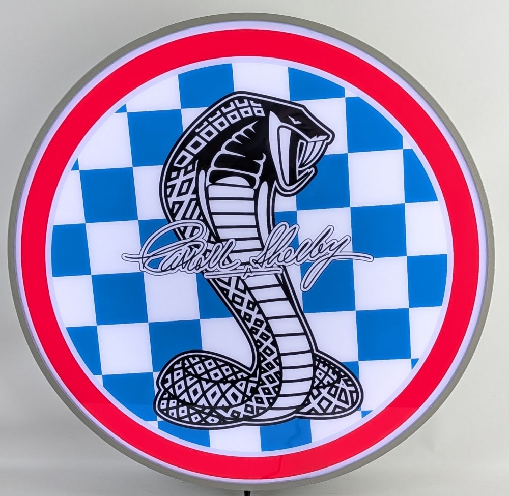 2-1/2ft Custom Shelby Cobra Racing Lighted Dealership Style Sign: Custom Shelby Racing lighted dealership style advertising sign. Features a metal can and plastic / acrylic face. Appears to be in nice working condition with light wear from display and storage. It