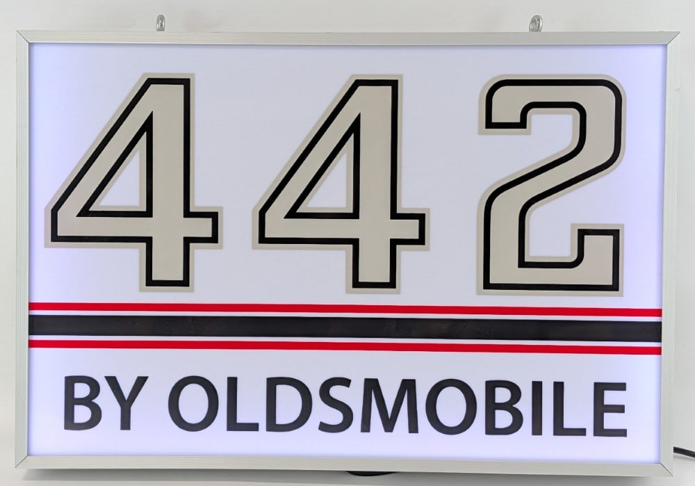 Custom Oldsmobile 442 Lighted Dealership Style Sign: Custom Oldsmobile 442 lighted dealership style advertising sign. Features a metal can and plastic / acrylic face. Appears to be in nice working condition with light wear from display and storage. Meas