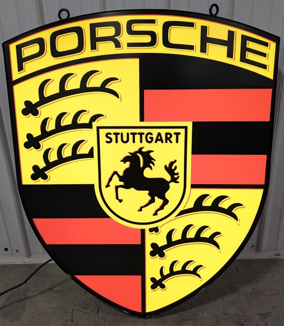 Large Custom Porsche Lighted Shield Sign: Large custom single sided Porsche lighted advertising sign. It features a metal can and plastic face. Nice working condition with light wear from displays and storage. It measures approximately 46in t