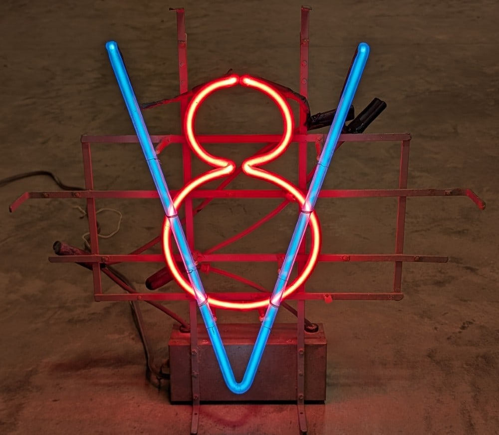 Vintage Ford V8 Dealership Neon Advertising Sign: Vintage Ford V8 dealership neon advertising sign. Appears to be in good working condition with some surface rust, paint loss, and wear on the metal frame and transformer. It measures approximately