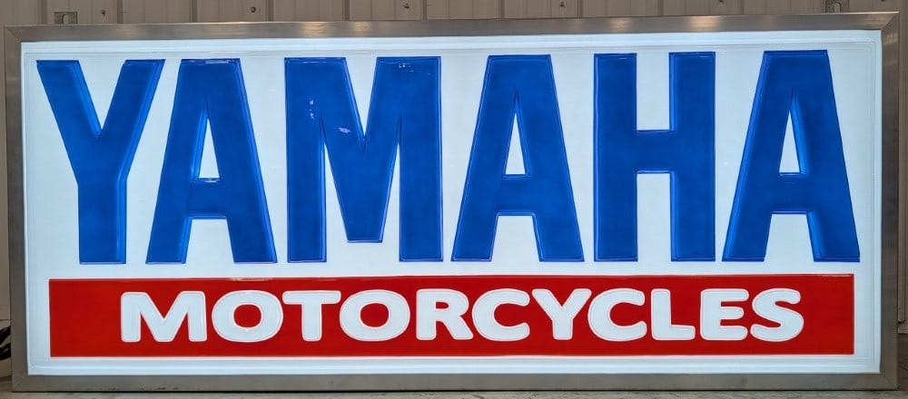 6ft Custom Yamaha Motorcycles Embossed Lighted Sign: Large high quality custom made Yamaha Motorcycles lighted sign. It features a heavily embossed plastic sign face and high quality metal frame with hanging brackets. It appears to be in nice working co