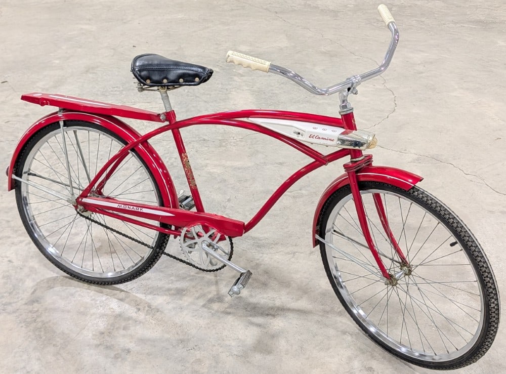 Vintage Monark El Camino Bicycle: Vintage Monark El Camino bicycle. The bicycle shows paint loss and decal loss on the seat tube and light wear from use and age.