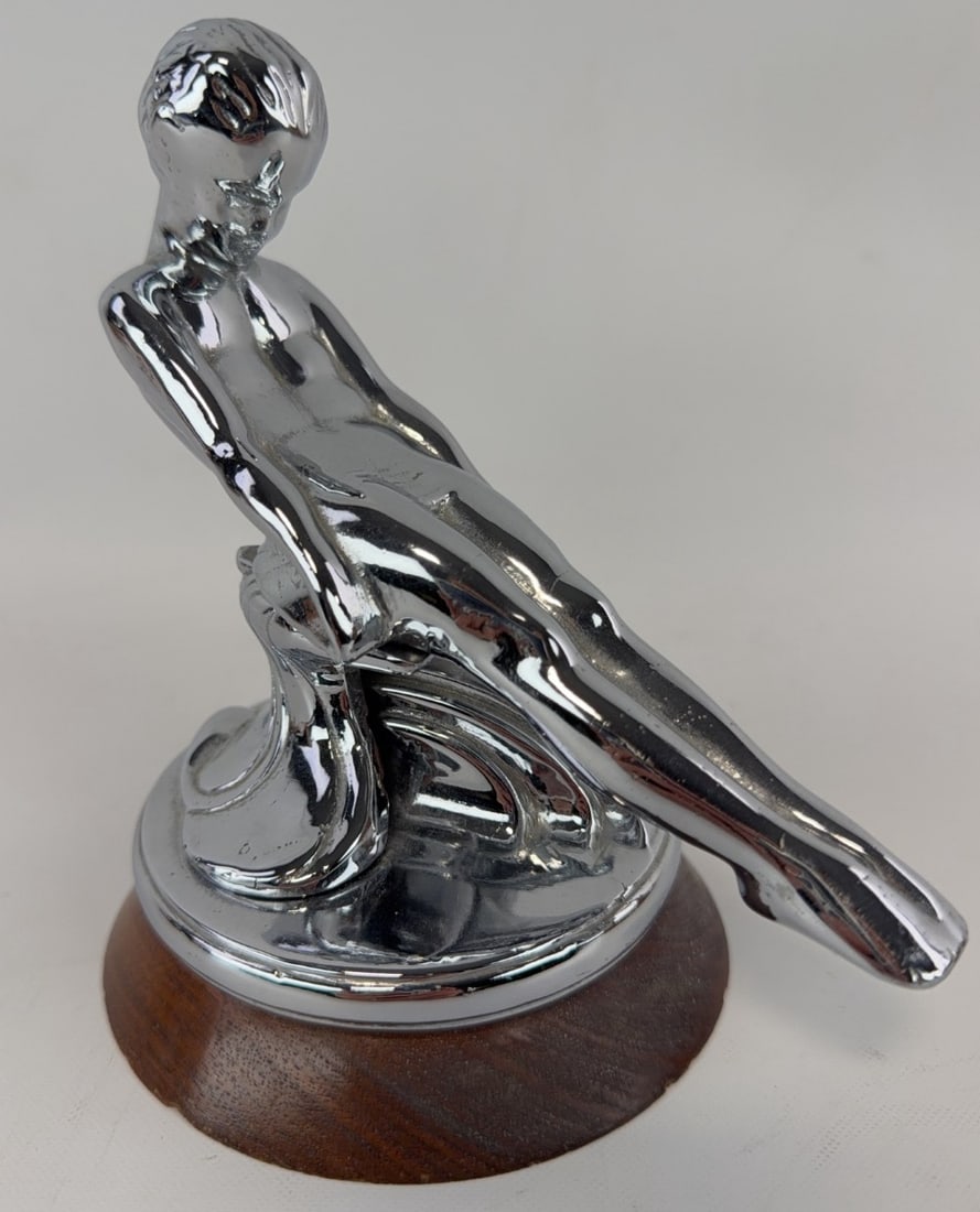 Packard Sliding Adonis Hood Mascot: Mounted to a wood base, chrome in fine condition, measures 6? tall with base.
