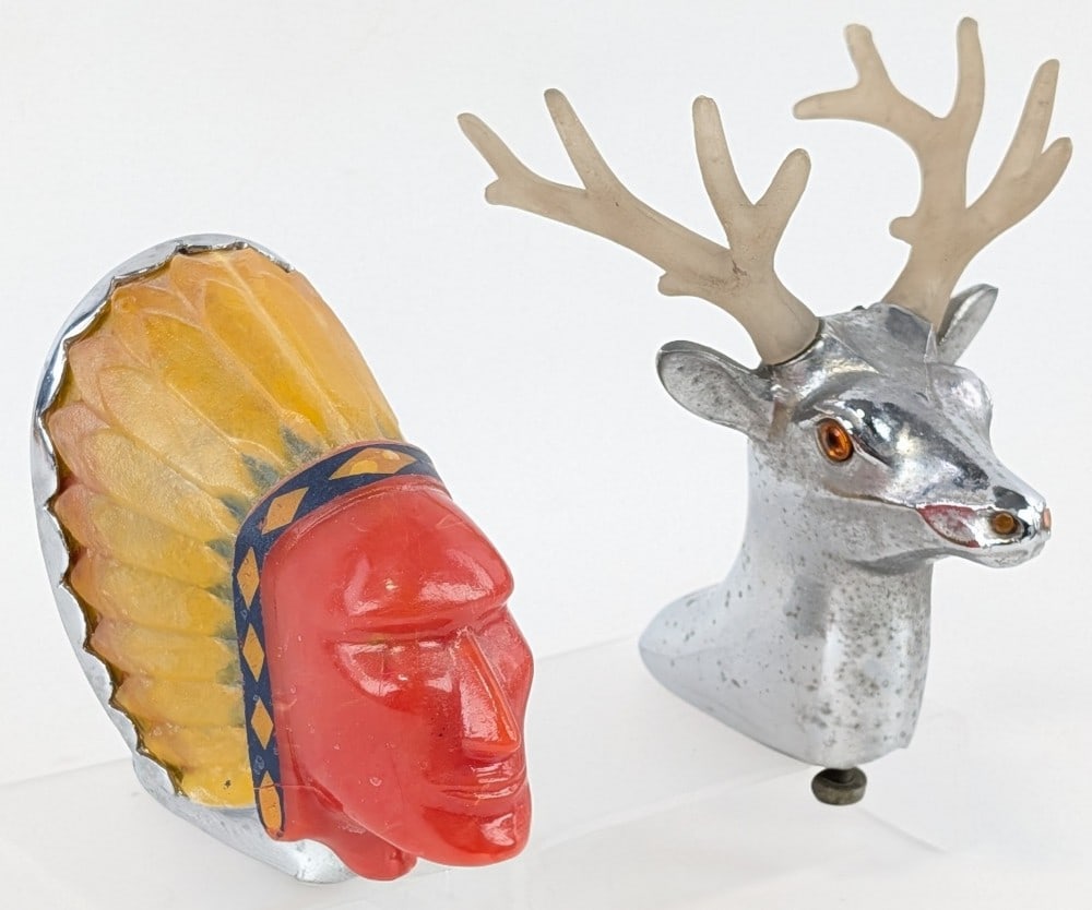 Pair of Illuminated Hood Mascots: Super Chief illuminated mascot, small hairline crack under the face, headdress in excellent condition, 4.25? tall. Blackstone illuminated buck mascot, antlers are removable antlers, slight wear to
