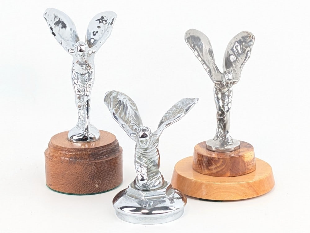 Lot of 3 Spirit of Ecstasy Rolls-Royce Mascots: Lot of 3 Spirit of Ecstasy Rolls-Royce hood ornaments, 2 mounted on wood bases. Tallest with base is 6.25?.