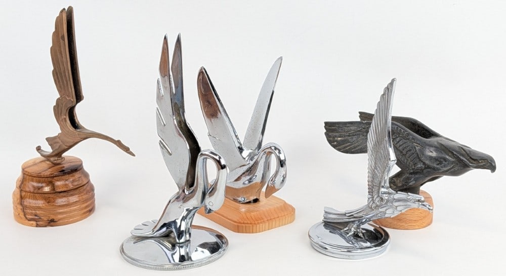 Group Of 5 Bird Hood Ornaments / Radiator Cap Mascots: Nice grouping of avian related hood ornaments. Lot includes a 2) Packard swans, a 1931-32 Pontiac Oakland Eagle , Cadillac Heron, and a large eagle / hawk mascot. They vary in age and condition.