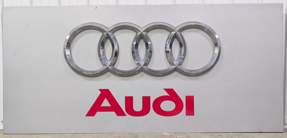 7ft Audi Dealership Metal Sign: Large single sided metal and plexiglass Audi dealership sign. Has scratches, scuffs, and other wear from use and storage. It measures approximately 85in across by 39in tall.