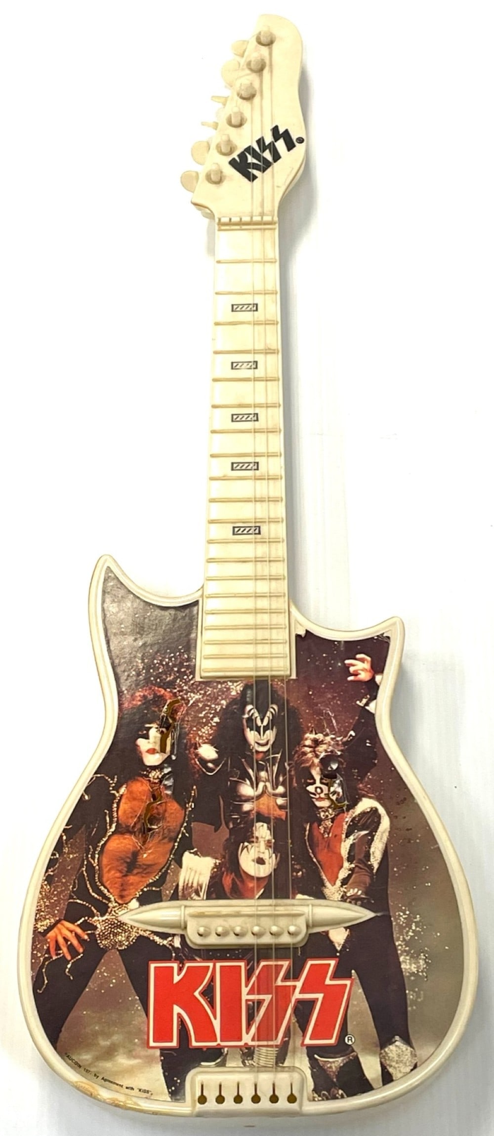 1977 Aucoin Kiss Toy Guitar: Original 1977 Aucoin Kiss Toy Guitar. Guitar is Missing 3 Strings and Some Damage on Front of Guitar and some fading. Guitar Measures 29.5? tall