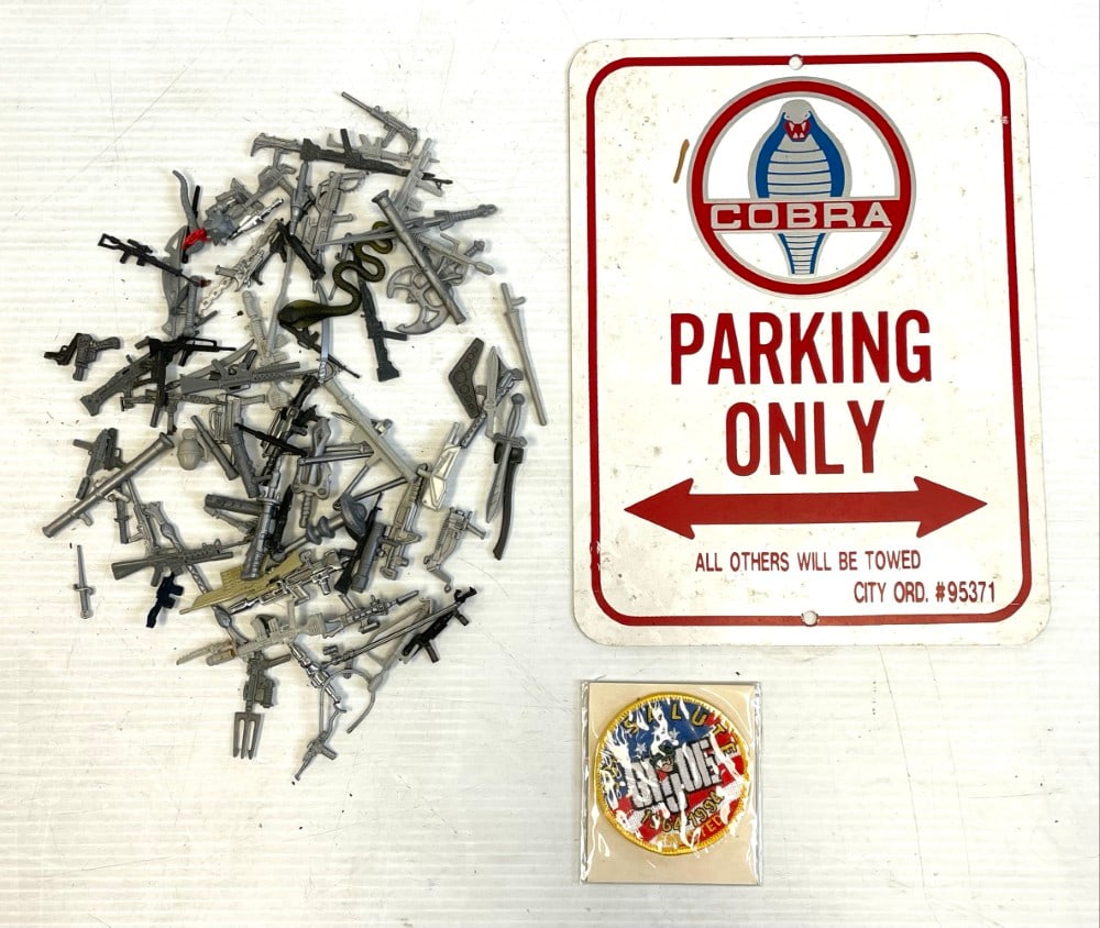 G.I. Joe Weapon Accessories and Metal Sign: G.I. Joe Weapon Accessories and Metal Sign. Approximately 50+ Weapon Accessories and Metal Sign 9? x 12? and Badge. Accessories are in varying conditions.