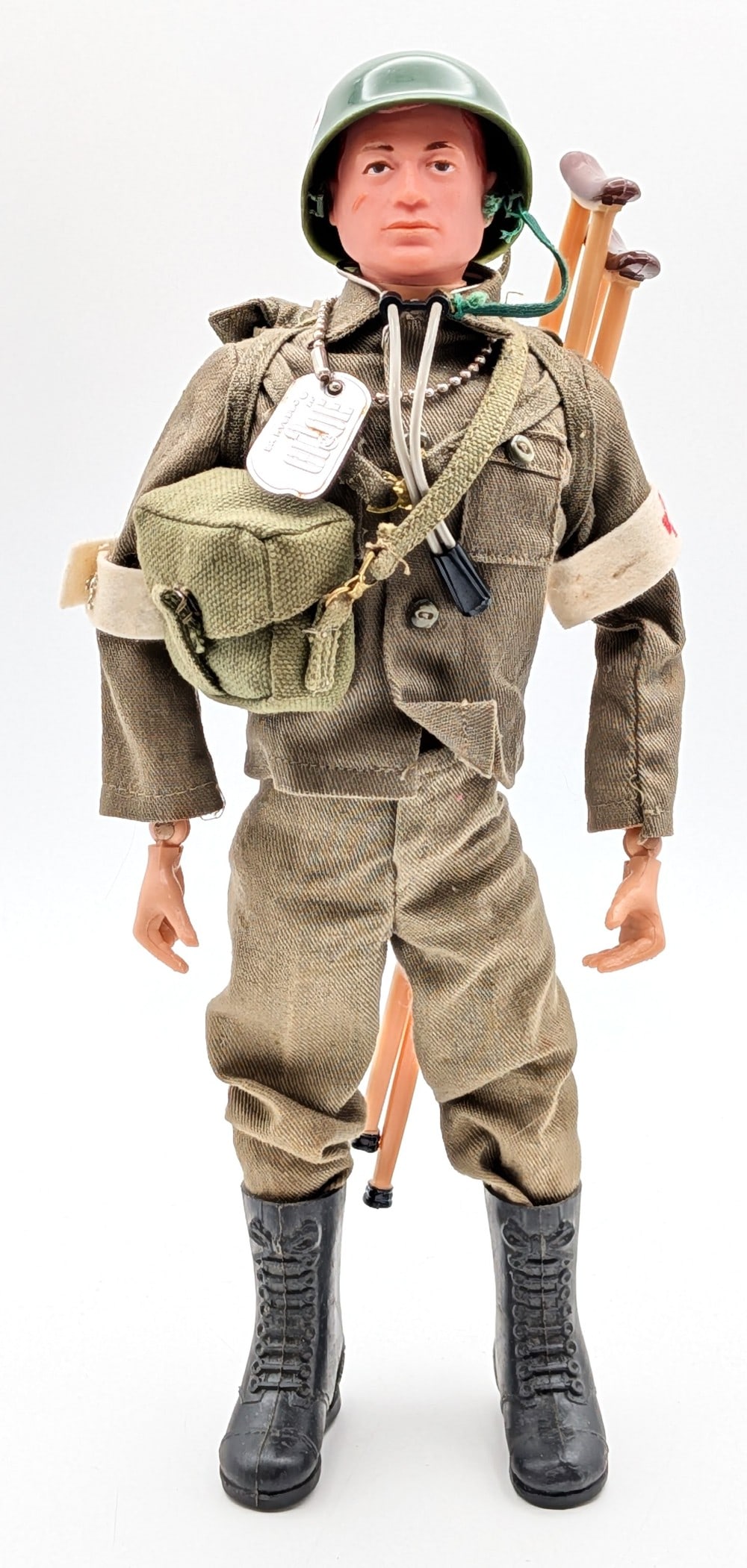 Vintage Hasbro GI Joe Action Soldier Medic: Vintage Hasbro GI Joe action soldier medic. The figure comes with its arm bands, dog tag, helmet, stethoscope, crutches, bag, outfit, and boots. The soldier shows the usual stress cracks and light wea