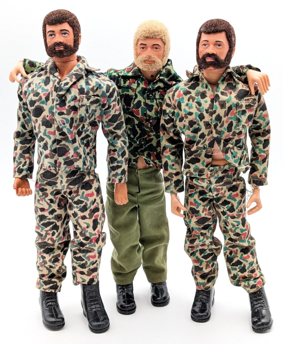 (3) Vintage Hasbro GI Joe Action Soldiers w/ Camouflage Outfits: (3) Vintage Hasbro GI Joe action soldiers with camouflage outfits. The figures all have life like flocked hair. The one shows some hair loss. They all show some stress cracks and the usual wear from