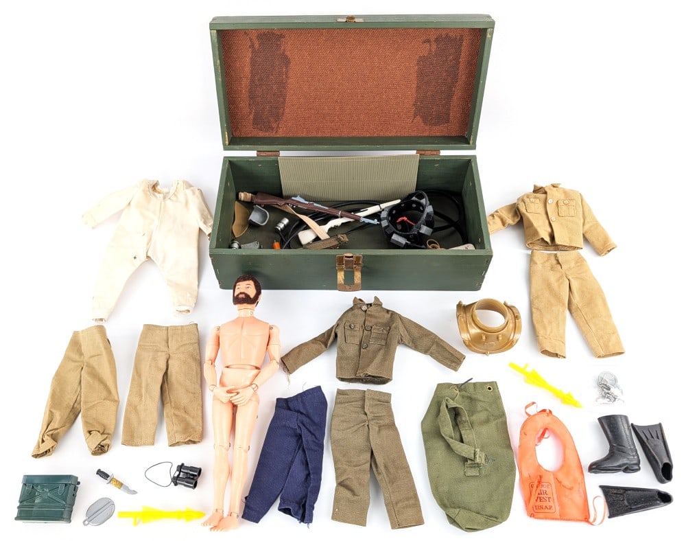 Vintage Hasbro GI Joe Figure w/ Footlocker, Outfits, & Accessories: Vintage Hasbro GI Joe figure with footlocker, outfits, and accessories. The accessories include guns, boots, life vest, and miscellaneous outfits. The figure has flocked life like hair.