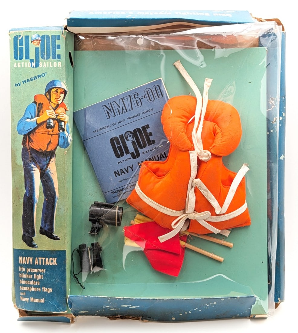 Vintage Hasbro GI Joe Action Sailor Navy Attack Outfit in Package: Vintage Hasbro GI Joe Action Sailor Navy Attack outfit in the original package. It comes with a life preserver, blinker light, binoculars, semaphore flags, and navy manual. The pieces are still tied d