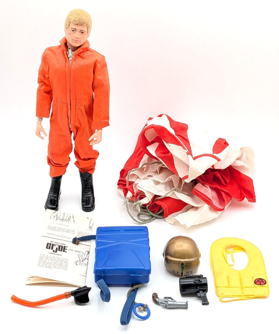 Vintage Hasbro GI Joe Action Pilot Figure: Vintage Hasbro GI Joe action pilot figure with accessories. Includes parachute, helmet, blinker light, best, orange jumpsuit, boots, and parachute instructions. The figure has the usual stress cracks