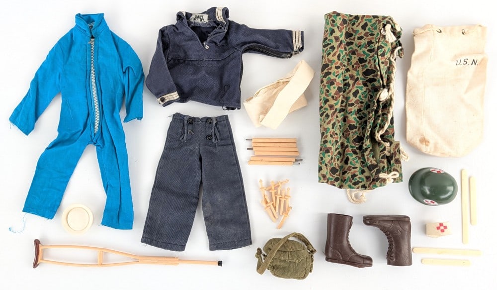 Vintage Hasbro GI Joe Outfits and Accessories: Vintage Hasbro GI Joe outfits. Includes accessories for the medic, Navy Sailor outfit, camouflage tent, and blue jumpsuit. The items show wear from play and age.