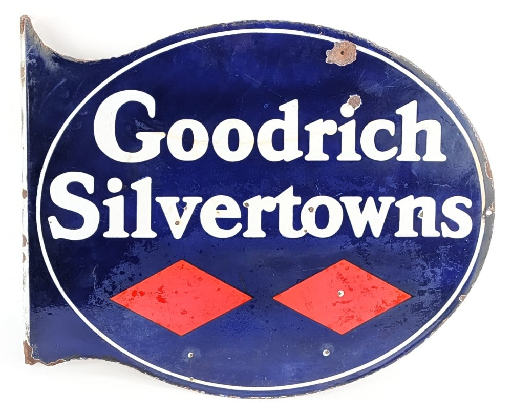 Goodrich Silvertowns w/Logo Porcelain Flange Sign (TAC): Vintage double sided porcelain Goodrich Silvertowns advertising flange sign. The sign shows porcelain chips, damage to the flange, and wear throughout. Measures approximately 23" across by 19" tall. T
