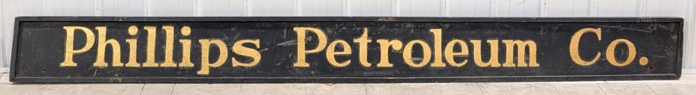 10FT Phillips Petroleum Co. Smaltz Painted Wood Sign (TAC): Large Phillips Petroleum Co. Smaltz painted wood framed sign. The sign has smaltz loss and wear from age and storage. Displays well with bright gold paint. Measures approximately 120" across by 11-1/2
