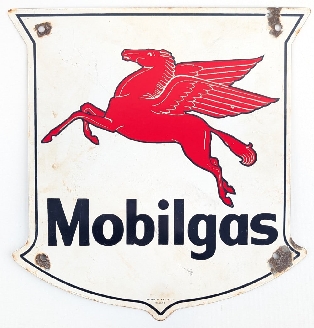 SSP Mobilgas Pump Plate Sign: Single sided porcelain Mobilgas pump plate sign. The sign displays well with good color and Pegasus graphics. The sign has chips around the mounting holes, discoloration, and wear from age. It is mark