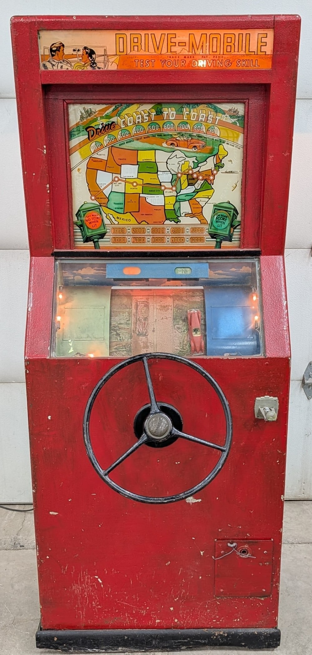 Early Mutoscope Drive-Mobile Coin Op Arcade Game: Early Mutoscope Drive-Mobile Coin Operated driving skill arcade game. Worn original condition with missing back door. Has paint loss and other damage / wear from use, age , and storage. Does not work